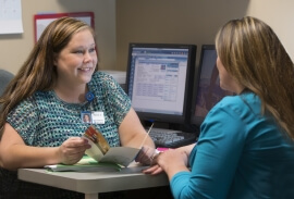 Care Coordinator Aaryn Ackley helps a patient